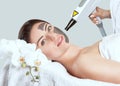 Carbon face peeling procedure in a beauty salon. Hardware cosmetology treatment Royalty Free Stock Photo