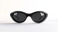 Carbon fiber frame cat eye sunglasses resting on a white surface Royalty Free Stock Photo