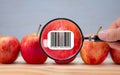 Carbon footprint bar code label on apple magnified by magnifying lens Royalty Free Stock Photo