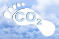 Carbon footprint concept with CO2 text against footprint on cloudy sky background - CO2 Neutral and ecological concept with foot Royalty Free Stock Photo