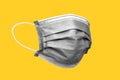 carbon medical face mask isolated on yellow background with clipping path Royalty Free Stock Photo