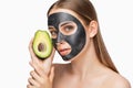 Carbon peeling procedure to beautiful girl in a beauty salon. Girl with avocado.Hardware cosmetology treatment