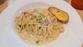 Carbonara fettucini with garlic bread plating Royalty Free Stock Photo
