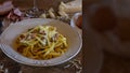 Carbonara pasta dish, typical Italian recipe with parmesan cheese, egg cream and bacon. Space for text. Selective focus Royalty Free Stock Photo