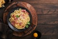 Carbonara pasta. Spaghetti with pancetta, egg, parmesan cheese and cream sauce on old dark black wooden table background. Royalty Free Stock Photo