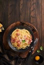 Carbonara pasta. Spaghetti with pancetta, egg, parmesan cheese and cream sauce on old dark black wooden table background. Royalty Free Stock Photo