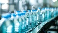 Carbonated water bottles on a factory conveyor undergo quality check