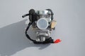 Carburettor for scooter on a gray background Royalty Free Stock Photo