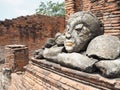 Carcass of broken buddha statue and ancient building