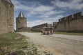 Carcassonne, France June 25, 2019: Tourists ride on a horse-drawn vehicle around Carcasson, a fortificated castle, a UNESCO World