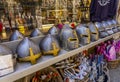 Carcassonne, France - 02.07.2021: Medieval helmets, Toy wooden swords for sale in a toyshop. Shop of tourist souvenirs