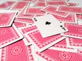 A card with a club suit on a pile of scattered cards from the deck with a red back Royalty Free Stock Photo