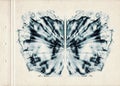 Card of color Rorschach inkblot test. A sheet of old paper stained with blue symmetric watercolor blots. Grunge artistic backgroun Royalty Free Stock Photo