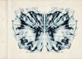 Card of color Rorschach inkblot test. A sheet of old paper stained with blue symmetric watercolor blots. Grunge artistic backgroun