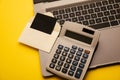 Card in a craft envelope, laptop keyboard and calculator on a yellow background Royalty Free Stock Photo
