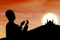 Card design silhouette of muslim man praying at sunset