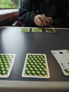 card games on a train yellow blue table person dealing