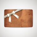 Card with grunge cardboard texture and a white ribbon Royalty Free Stock Photo