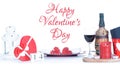 Greeting card Happy Valentine`s Day. Laid table with wine and hearts isolated with the inscription
