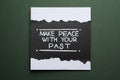 Card with life-affirming phrase Make Peace With Your Past on dark green background