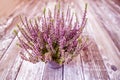 card in lilac tones, Veres plant. Old wooden background.