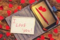 Card with Message Love You. Handwritten text the tablet and pen. Letter Valentine`s Day Royalty Free Stock Photo