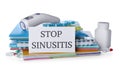 Card with phrase STOP SINUSITIS, non-contact thermometer and different drugs on background