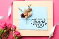 Card with phrase Thank You and beautiful flowers on pink background, flat lay Royalty Free Stock Photo