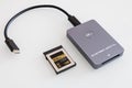 card reader for cfexpress memory cards on a white background. 512 GB memory card inside. Royalty Free Stock Photo