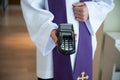 Card reader in the hand of a priest during a pastoral visit. Royalty Free Stock Photo