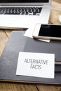 Card saying Alternative Facts on note pad