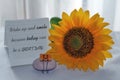 Card with sunflower and inspirational messages on a notepaper - Wake up and smile because today can be a great day.