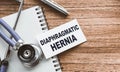 A card with text Diaphragmatic hernia on wooden doctor`s table