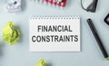 card with text FINANCIAL CONSTRAINTS, business concept image with soft