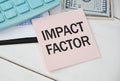 Card with text IMPACT FACTOR on white background, near office supplies and alarm clock. Royalty Free Stock Photo