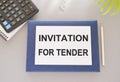 Card with text INVITATION FOR TENDER, business concept image with soft focus background