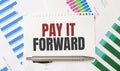 Card with text PAY IT FORWARD. Diagram and white background Royalty Free Stock Photo