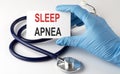 Card with text SLEEP APNEA , pills and stethoscope. Medical concept Royalty Free Stock Photo