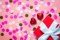 Card for valentine`s day. on a pink background gift and red shiny hearts. funny congratulations. Flat lay, top view Royalty Free Stock Photo