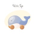 Card with wooden whale push toy.