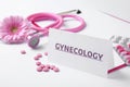 Card with word Gynecology, pills, stethoscope and flower Royalty Free Stock Photo