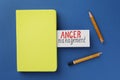 Card with words Anger Management, notebook and broken pencil on blue background, flat lay Royalty Free Stock Photo