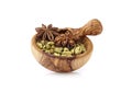 Cardamom and anise in wooden bowl on white background. Spices isolated Royalty Free Stock Photo