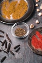 Cardamom, chilli, curry dishes on the slate partial blur