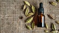 cardamom essential oil on burlap background