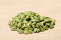 Cardamom pods in a wooden bowl