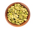 Cardamom seeds in wooden bowl, isolated on white background. Pile of green cardamom. Top view Royalty Free Stock Photo