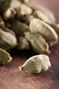 Cardamome seeds on wooden table Royalty Free Stock Photo