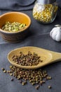 cardamon clay pot, sichuan paper in wood spoon, chilli paper and juniper berry, garlic and corn in glass jar