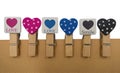 Cardboard background with clips with heart and lettering LOVE avd SMILE